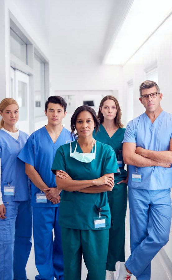 Portrait Of Multi-Cultural Medical Team Standing In Hospital Corridor